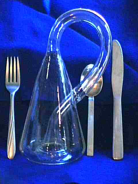 Next to a knife, fork, and spoon, here's a tasty Erlenmeyer Klein Bottle
