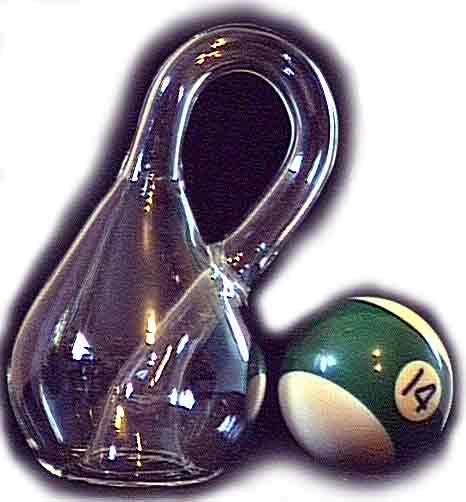 A medium size Klein Bottle next to a billiard ball